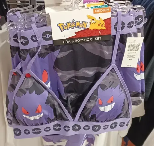 A Gengar bra and boy shirt set with Gengar on both breasts of the bra and Gengar on both legs of the shorts. It is sold in a store for what looks to be $26.99. Gengar is a Pokemon, and this merch is officially licensed for sure.